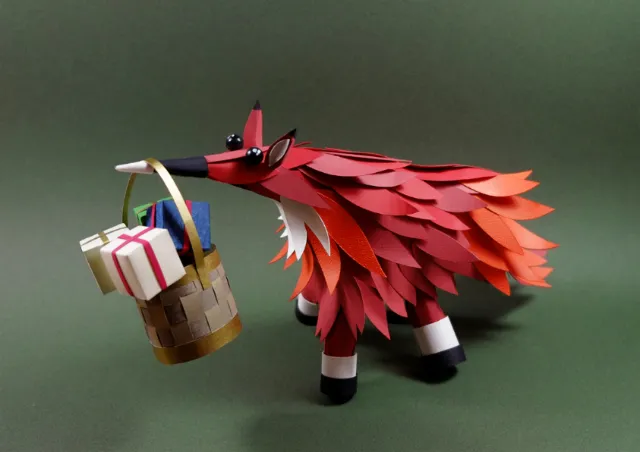 Paper fox sculpture holding a gift basket by Martha von Maydell