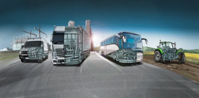 Heavy vehicles including truck, bus, and tractor on road by field by Björn von Schlippe