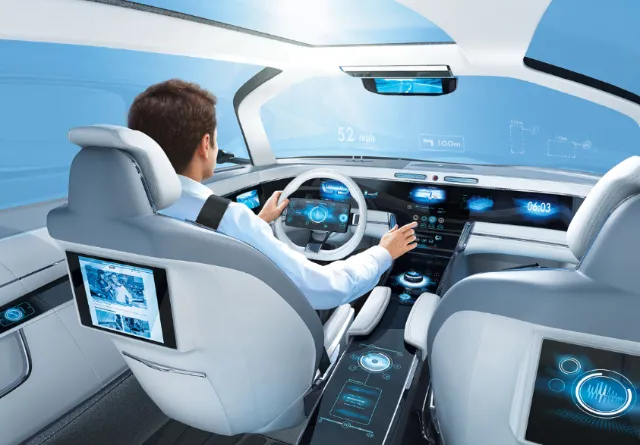 Man driving futuristic car with digital dashboard and touchscreens by Eberhard Reimann