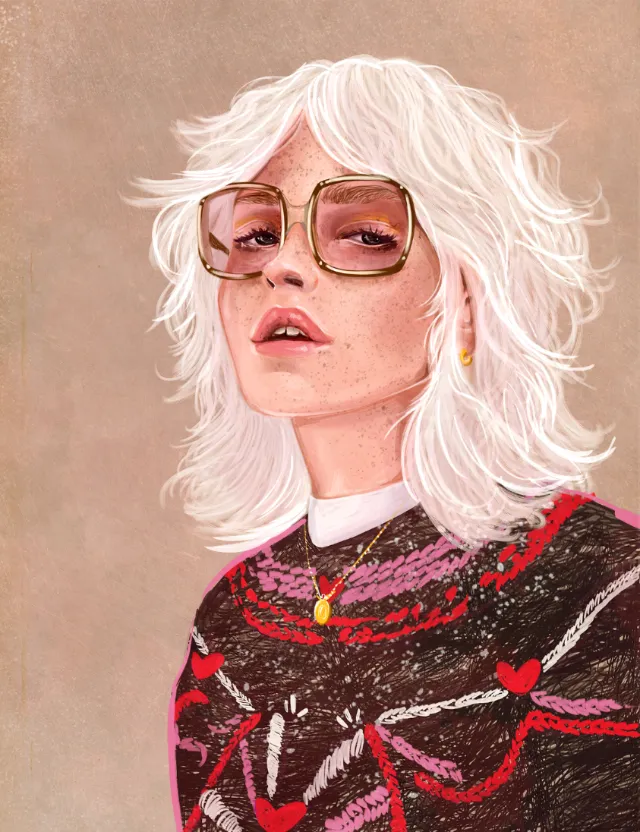 Woman with white hair and pink glasses wearing a vintage winter jacket by Amber Day