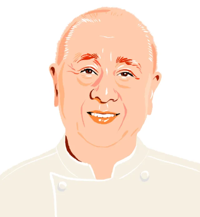 Smiling bald man in white chef uniform by Jessine Hein