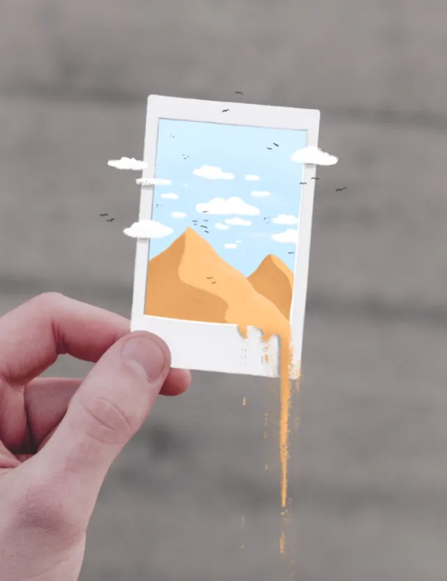 Hand holding a Polaroid photo of desert scene with sand flowing out by Samy Löwe