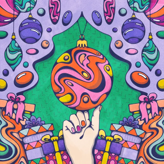 Hand balancing a colorful Christmas ornament amid hanging ornaments and gifts by Lively Scout