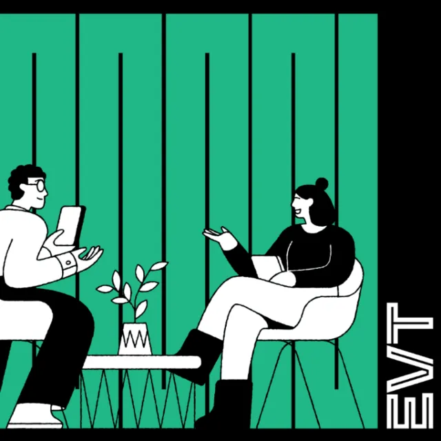 Two people talking indoors near a table with a plant by Joseph Carrington