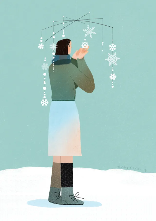Person holding snowflake mobile with winter outfit by Hao Hao