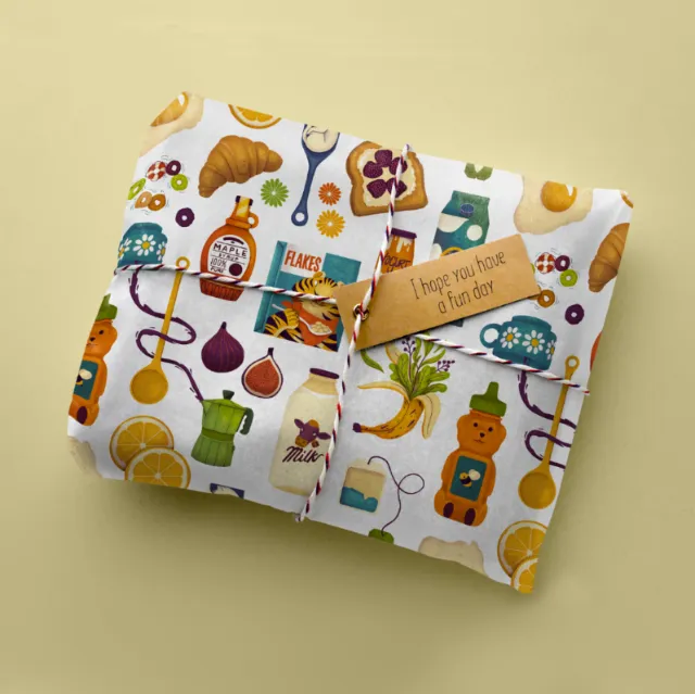 Fabric pouches with kitchen-themed patterns and a wooden tag by Luiza Laffitte