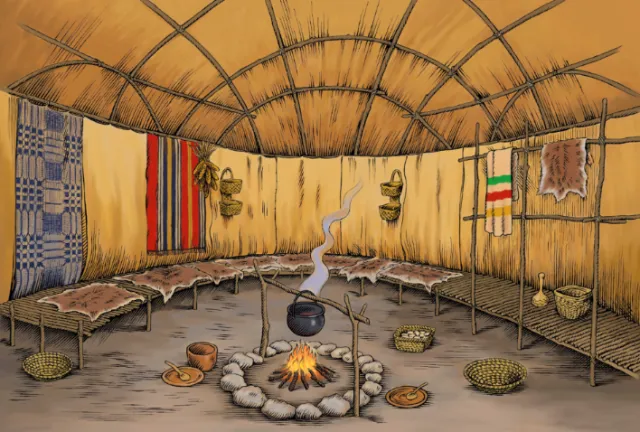Interior of traditional round hut with fire and hanging textiles by Martin Hargreaves