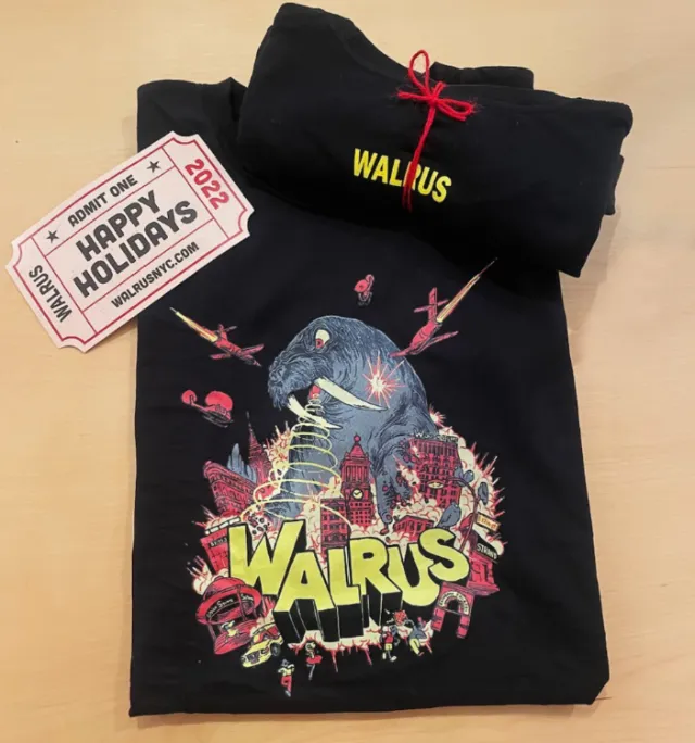 Black Walrus t-shirt with colorful graphic and holiday tickets by Carles Garcia O'Dowd