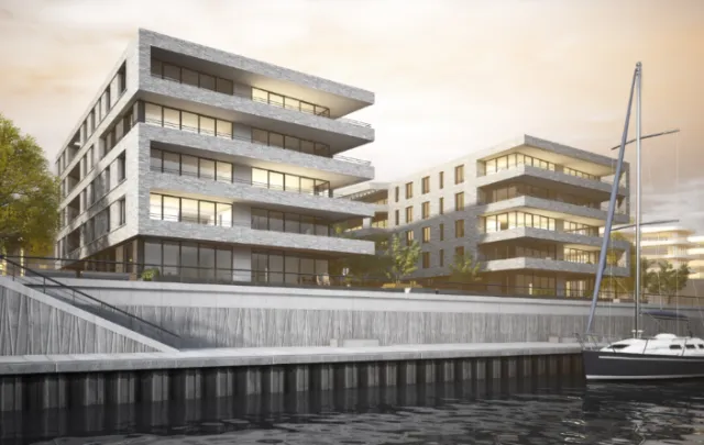 Modern waterfront residential buildings with dock and boats by Oliver Hasselluhn