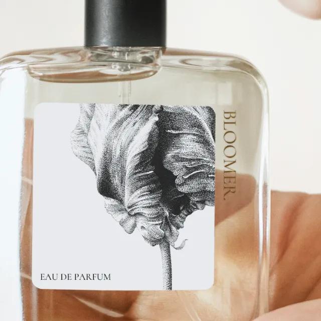 Glass perfume bottle with Bloom Eau de Parfum label and botanical illustration by Reiko Lauper