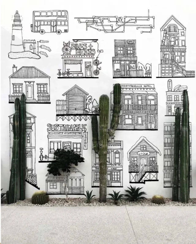 Wall mural with various architectural sketches and cacti by Ellie Compton