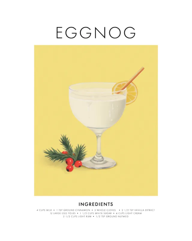 Glass of eggnog with lemon slice and holiday greenery