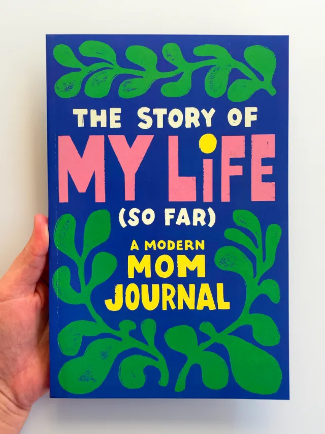 Book cover of The Story of My Life (So Far): A Modern Mom Journal with colorful text and green leaf