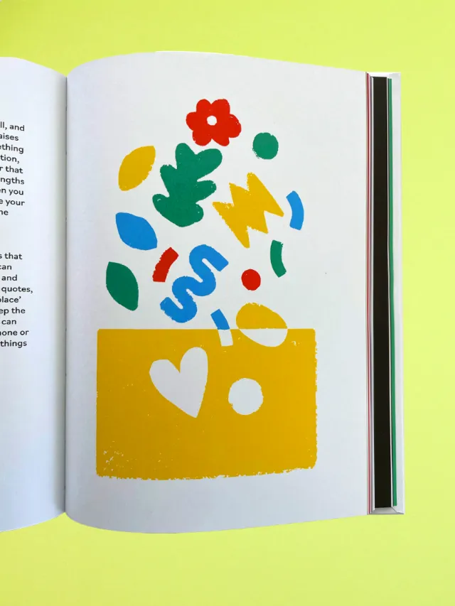 Colorful abstract shapes emerging from a yellow block on book page
