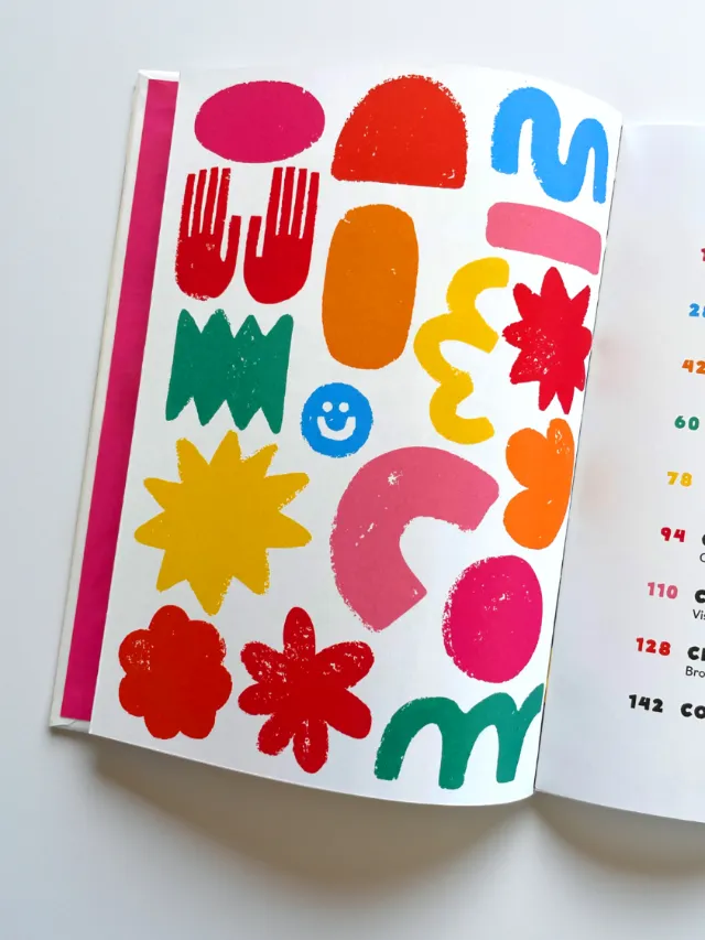 Colorful abstract shapes and symbols on an open book page