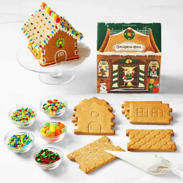 Gingerbread house kit with cookie pieces and decorations by Decue Wu
