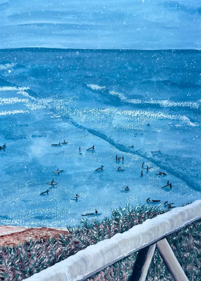 Ocean view with swimmers and surfers near the shoreline