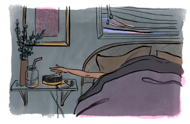 Person reaching for coffee cup on bedside table in morning