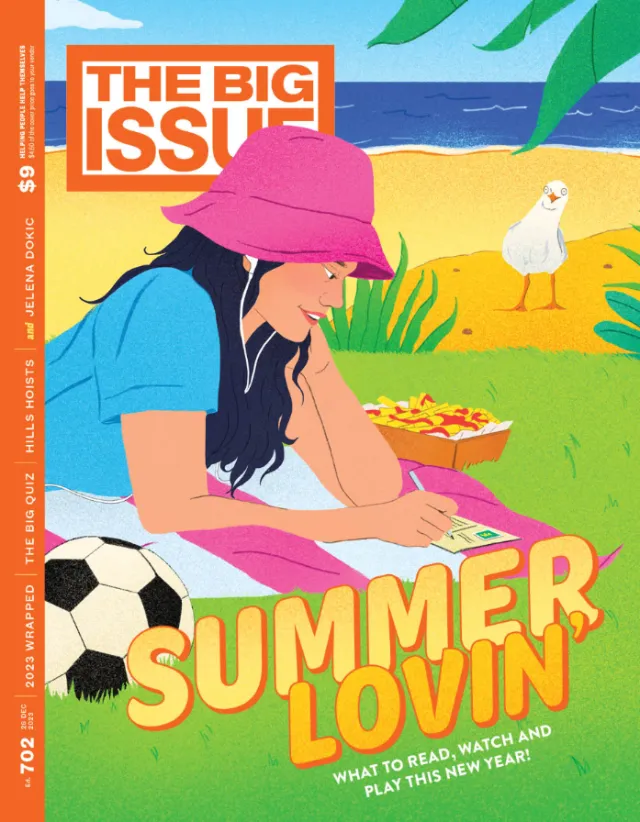 Woman writing on paper at beach with soccer ball and bird nearby