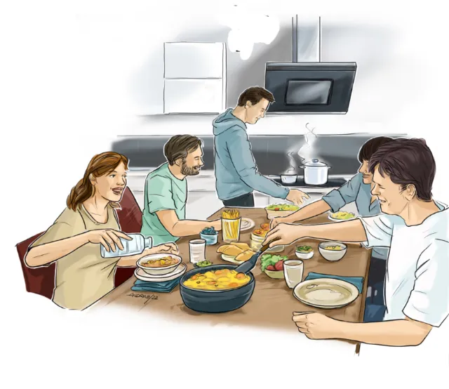 Friends eating and cooking together around a kitchen table