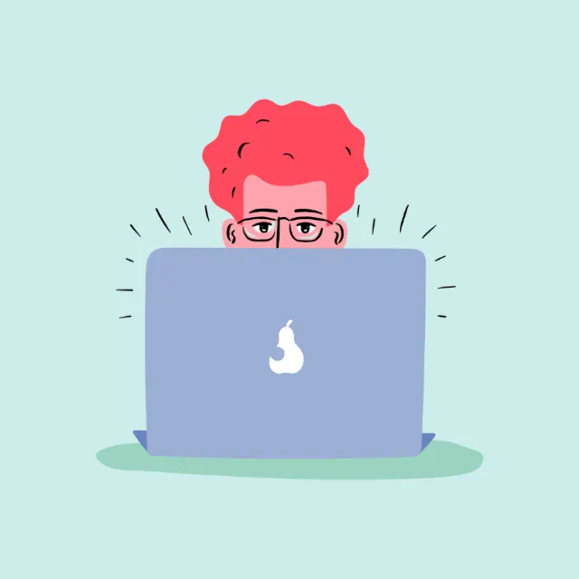 Person with red hair and glasses looking over laptop screen by Kate Snell
