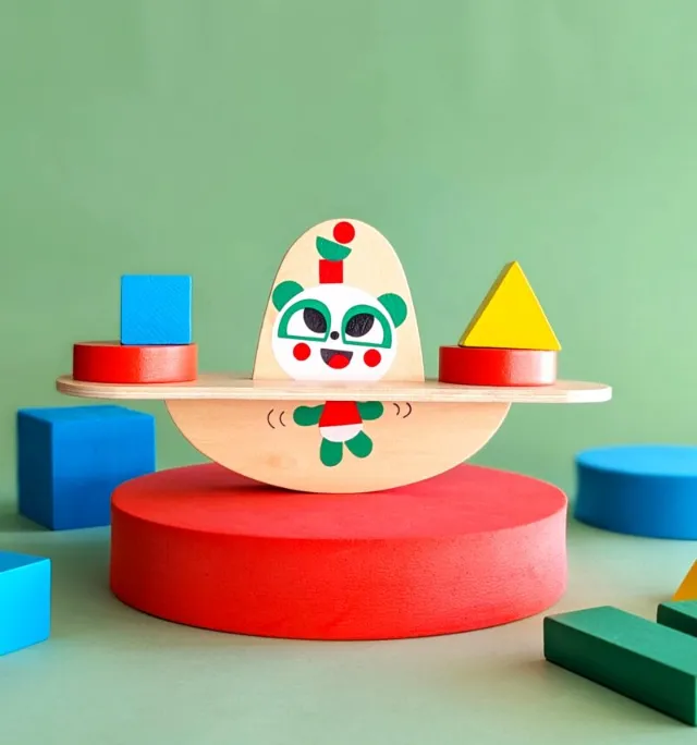 Wooden balancing toy with geometric shapes and panda illustration