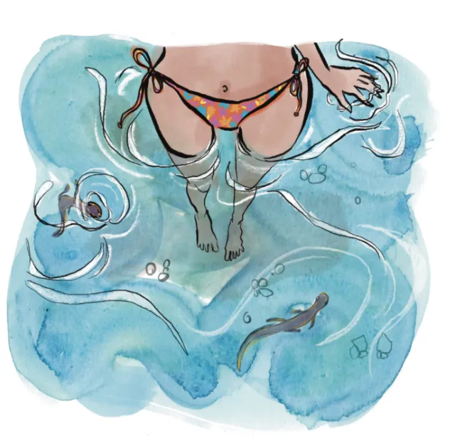 Woman floating in water wearing floral bikini bottom viewed from above