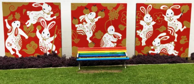 Colorful rabbit mural with red background and decorative patterns