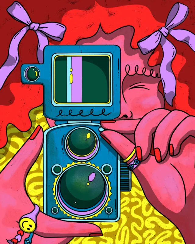Hands holding vintage camera with vibrant red and yellow patterns