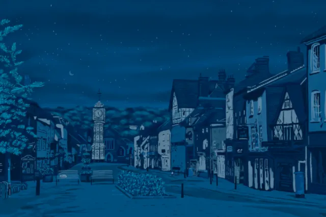 Nighttime street with historic buildings and clock tower by Georgie Stewart