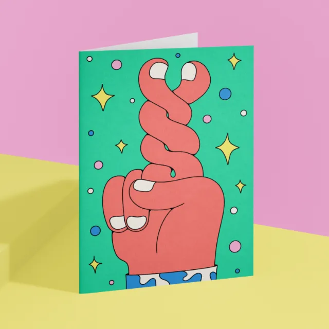 Illustration of a hand with crossed fingers on colorful card