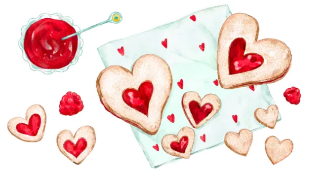 Heart-shaped cookies with red jam and a bowl of jam on napkin