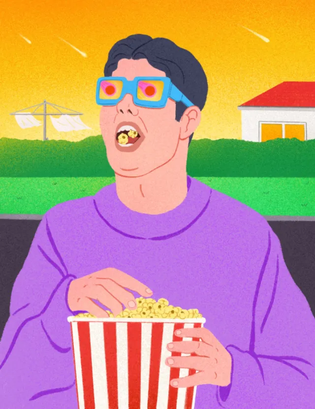 Person with 3D glasses eating popcorn outside during shooting stars