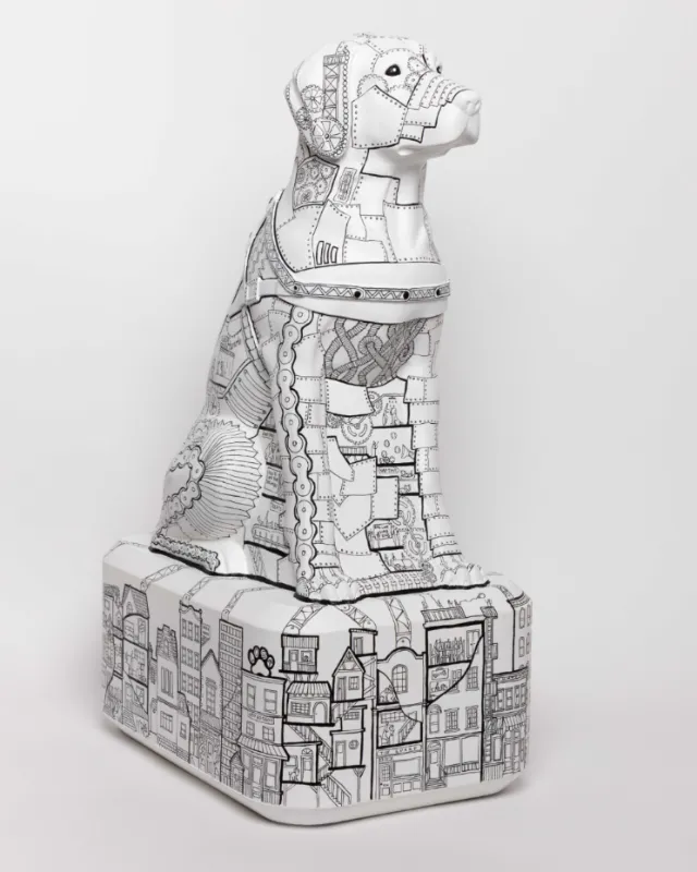 Detailed black and white geometric dog sculpture on pedestal