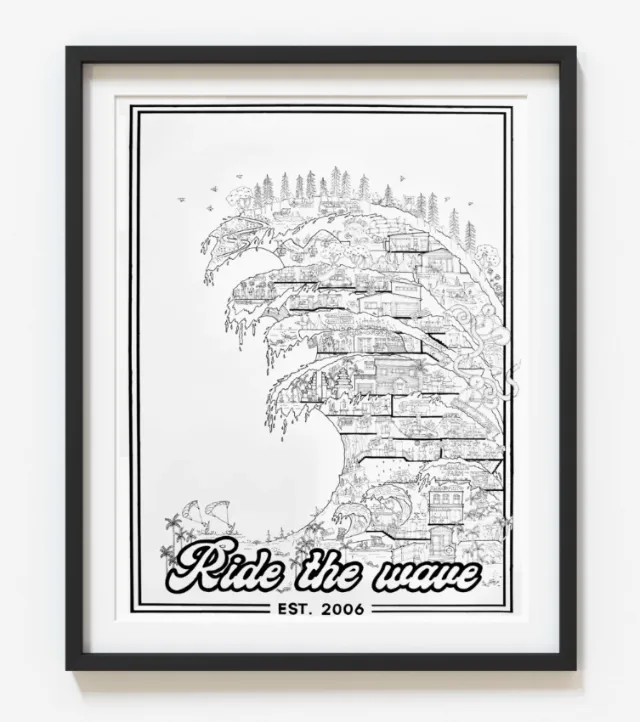 Framed black and white art showing a detailed wave with city elements