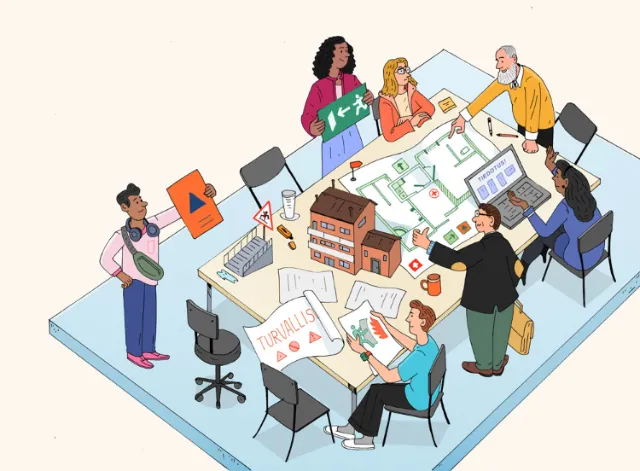 Group collaborating on architectural plans around a table