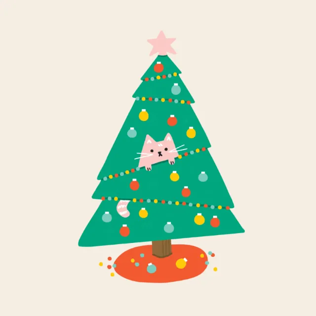 Cat peeking from inside a decorated Christmas tree with ornaments.