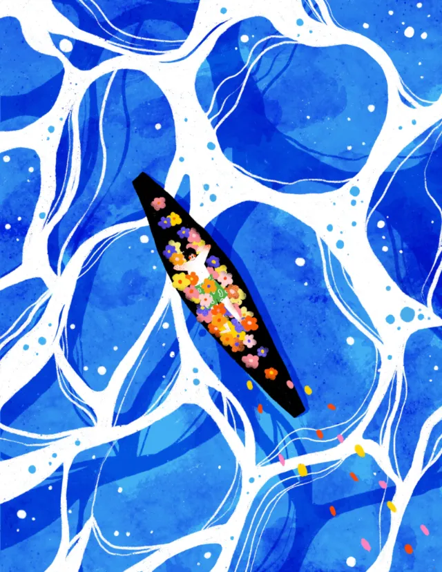 Boat filled with colorful flowers floating on blue ocean waves