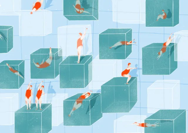 People swimming and diving in large transparent cubes in a pool