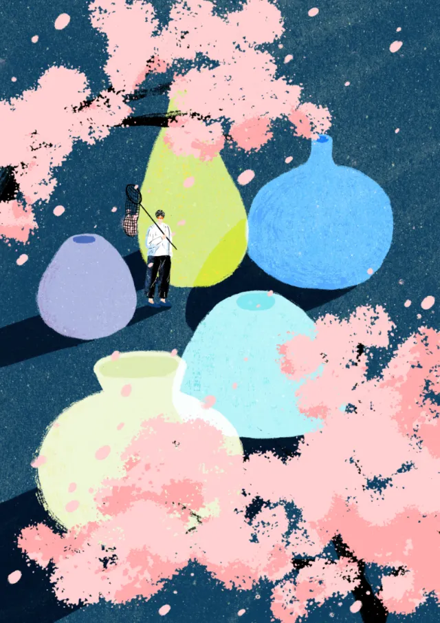 Person fishing near large colorful vases with pink blossoms