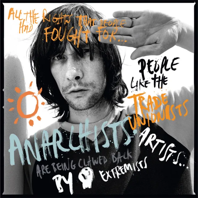 Black and white portrait of a man with graffiti-style text overlay