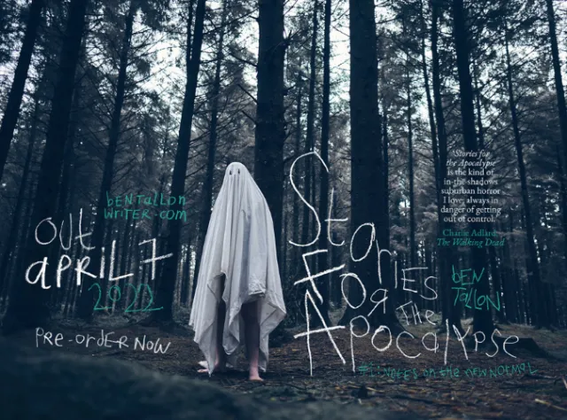 Person in white sheet costume standing in a dark forest