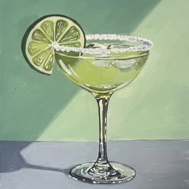 Margarita cocktail in a glass with salted rim and lime garnish