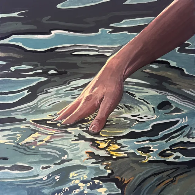 Hand touching water with ripples and light reflections
