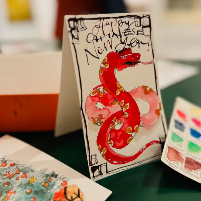 Chinese New Year card with a red snake and handwritten greeting