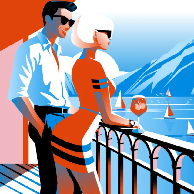 Couple by railing overlooking sailboats on blue sea with mountains