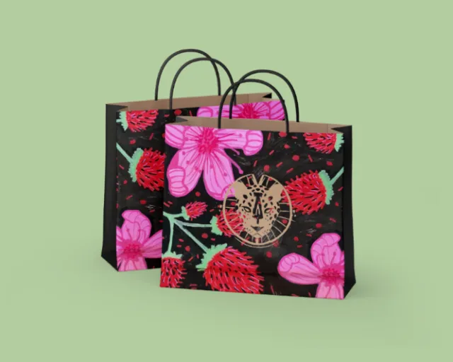 Black shopping bags with red and pink flower designs on green background