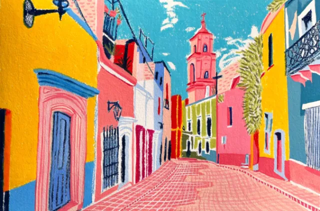 Colorful Mexican street with buildings and church tower