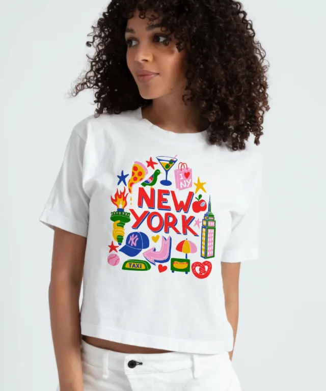 Woman in white T-shirt featuring colorful New York illustrations