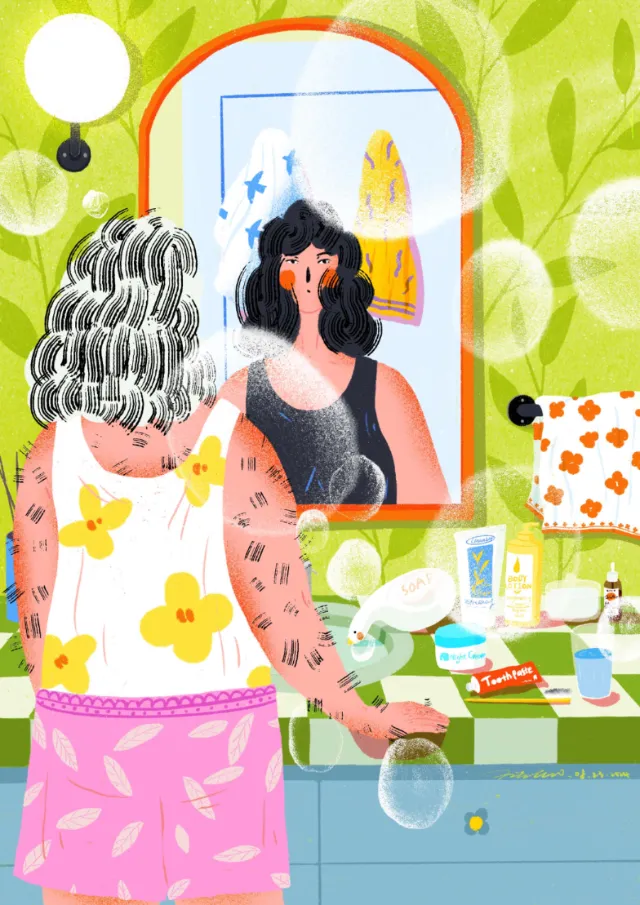 Woman looking at herself in a mirror in a colorful bathroom